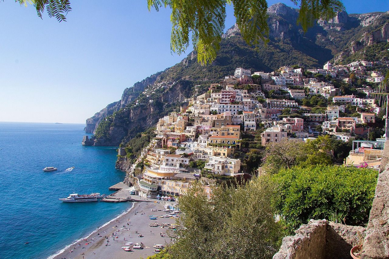 Positano on the Amalfi Coast, with colourful houses climbing the hillside above the beach and the sea.